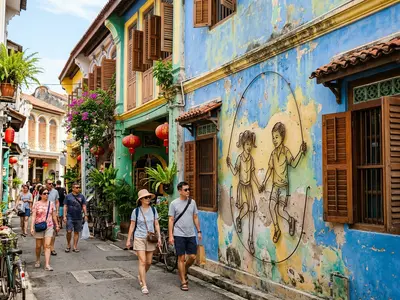 Street art and wire art installations on shophouse walls in George Town Penang